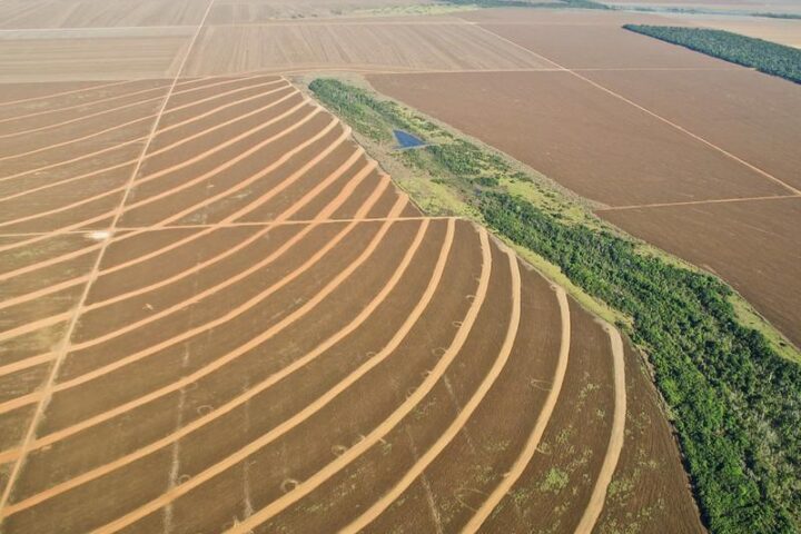 Aerial view of deforestation and agricultural expansion in Mato Grosso, Brazil, showing soybean and sugarcane plantations replacing Amazon rainforest.