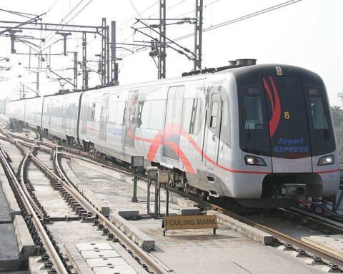 Delhi Metro Airport Express train on elevated tracks, representing urban connectivity and fare revisions in 2025.
