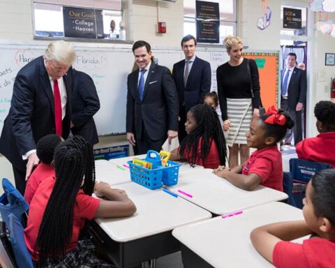 President Trump, Rubio, Kushner, and Ivanka Trump interact with fourth-grade students in a decorated classroom at Saint Andrew's Catholic School.