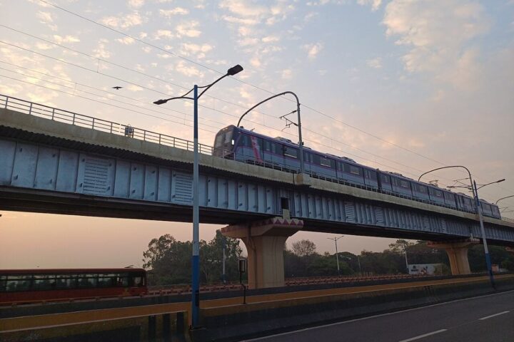 Pune Metro train running on the elevated viaduct between Bopodi and Dapodi during sunset.