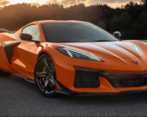 An orange 2025 Chevrolet Corvette Z06 supercar parked on an asphalt road.