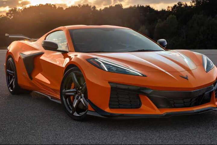 An orange 2025 Chevrolet Corvette Z06 supercar parked on an asphalt road.