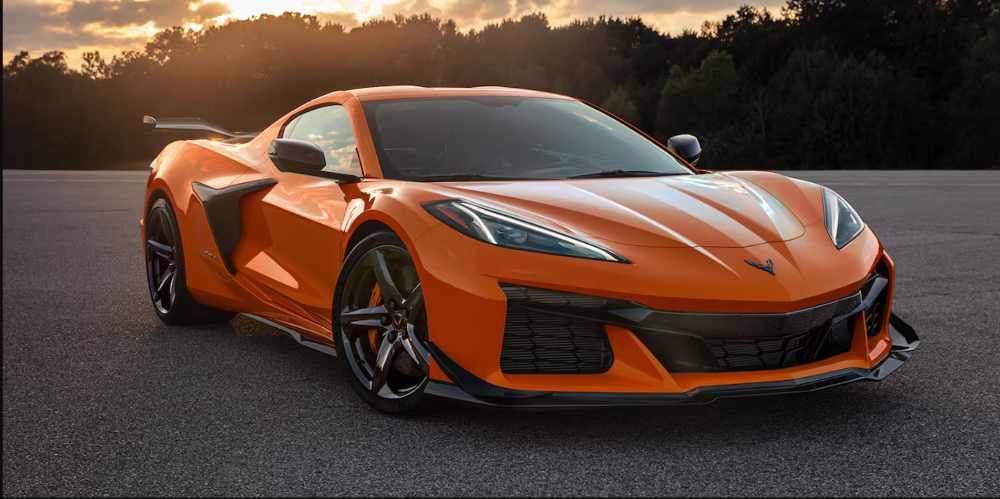 An orange 2025 Chevrolet Corvette Z06 supercar parked on an asphalt road.