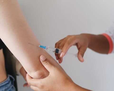 Close-up of a healthcare worker injecting a vaccine into an upper arm