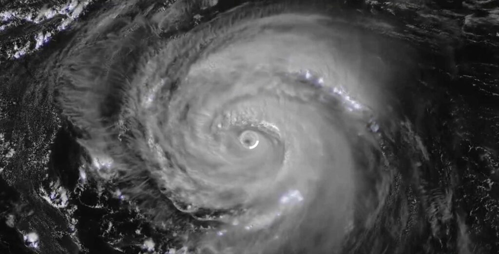 Satellite image of Hurricane Erin showing a well-defined eye surrounded by spiraling cloud bands, captured by NOAA GOES satellite on August 20, 2025.