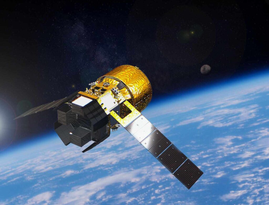 Artist rendering of JAXA HTV-X cargo spacecraft orbiting Earth with solar panels extended and cargo module visible against blue planet background