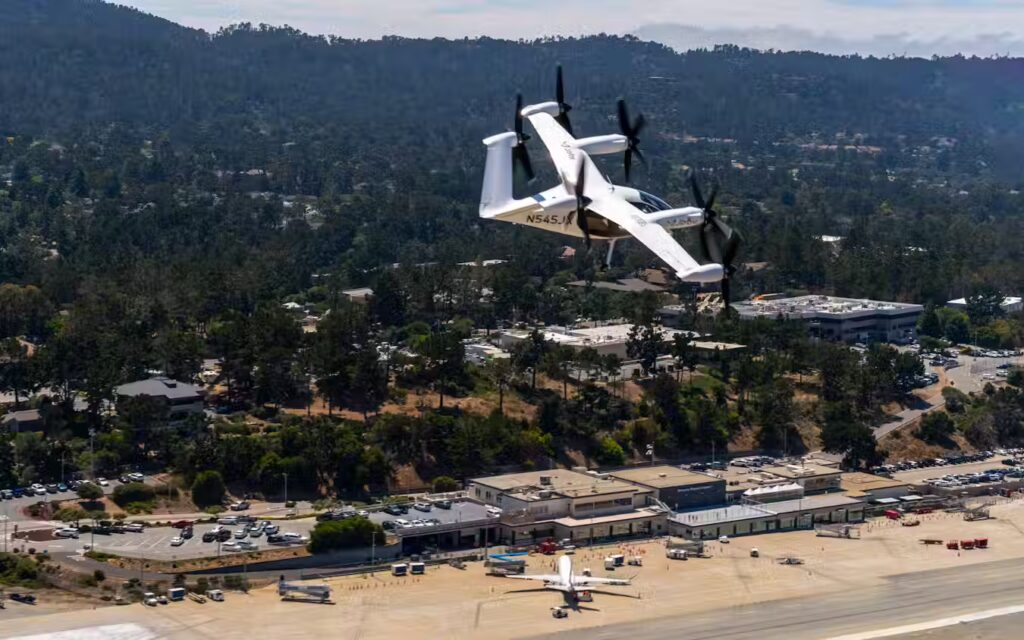 Joby Aviation electric eVTOL air taxi aircraft flying over residential area during historic first piloted flight between two US public airports in California