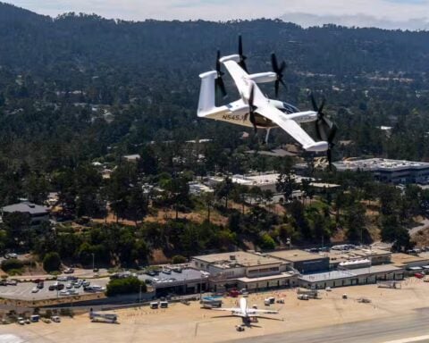 Joby Aviation electric eVTOL air taxi aircraft flying over residential area during historic first piloted flight between two US public airports in California