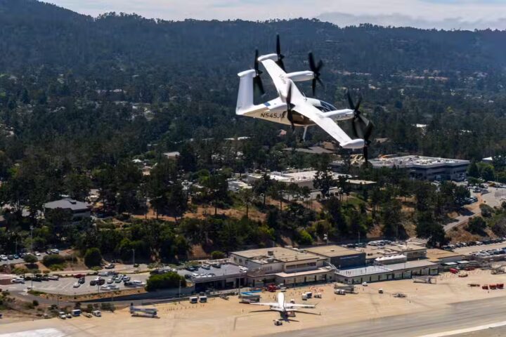 Joby Aviation electric eVTOL air taxi aircraft flying over residential area during historic first piloted flight between two US public airports in California
