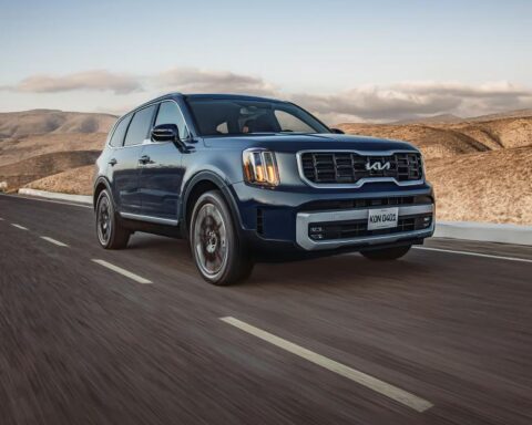 Kia Telluride SUV cruising through a desert highway