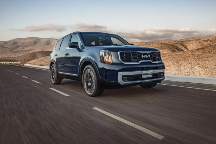 Kia Telluride SUV cruising through a desert highway