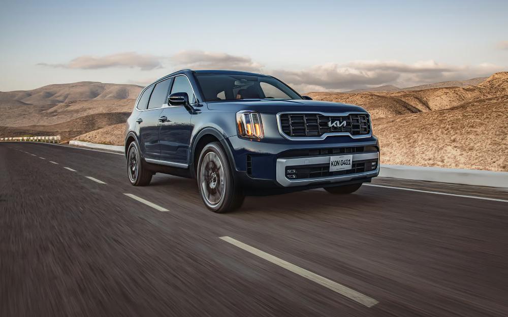Kia Telluride SUV cruising through a desert highway