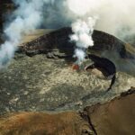 Aerial view of the Puʻu ʻŌʻō cone on Kīlauea with smoke and active lava, October 1997.