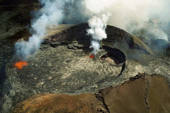Aerial view of the Puʻu ʻŌʻō cone on Kīlauea with smoke and active lava, October 1997.