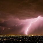 Lightning bolt illuminating a dark stormy sky over Adelaide, South Australia, during a spring thunderstorm, symbolizing extreme weather and emergency response efforts.