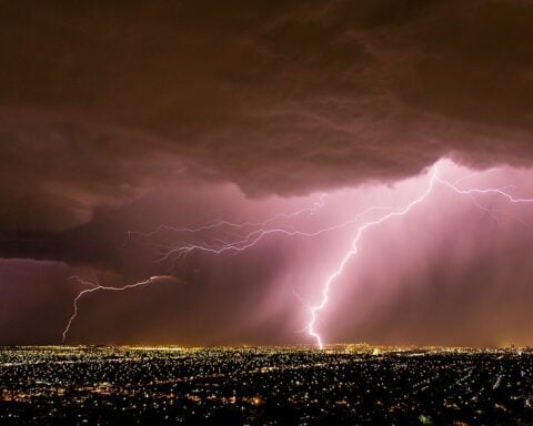 Lightning bolt illuminating a dark stormy sky over Adelaide, South Australia, during a spring thunderstorm, symbolizing extreme weather and emergency response efforts.