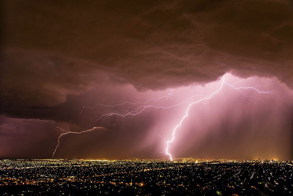 Lightning bolt illuminating a dark stormy sky over Adelaide, South Australia, during a spring thunderstorm, symbolizing extreme weather and emergency response efforts.