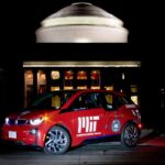 MIT's aluminum-powered electric vehicle prototype showcased in front of the iconic MIT Great Dome, demonstrating sustainable technology applications for clean energy.