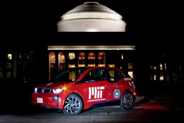 MIT's aluminum-powered electric vehicle prototype showcased in front of the iconic MIT Great Dome, demonstrating sustainable technology applications for clean energy.