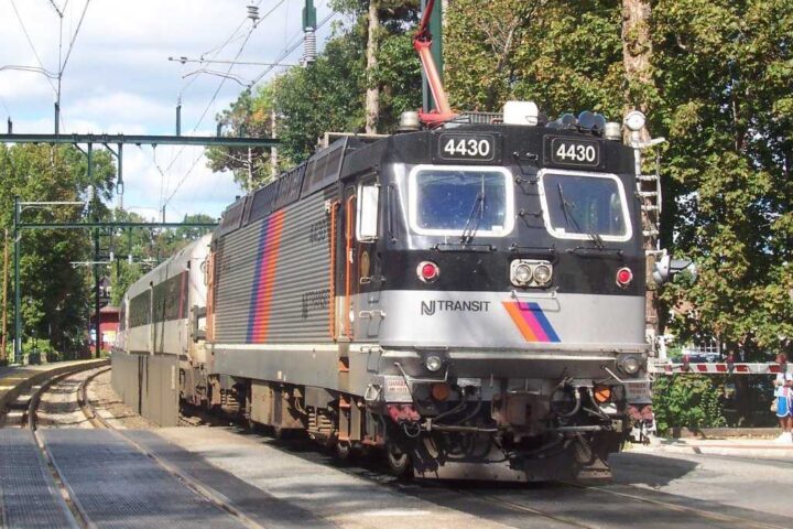 NJ Transit ALP-44M electric locomotive number 4430 traveling through a tree-lined section of track in New Jersey