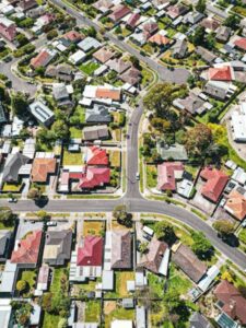 Aerial view of Melbourne residential neighborhood with rows of houses and streets, representing housing affordability and first home buyer policy changes in Australia.