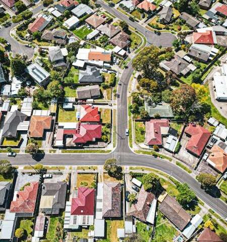 Aerial view of Melbourne residential neighborhood with rows of houses and streets, representing housing affordability and first home buyer policy changes in Australia.
