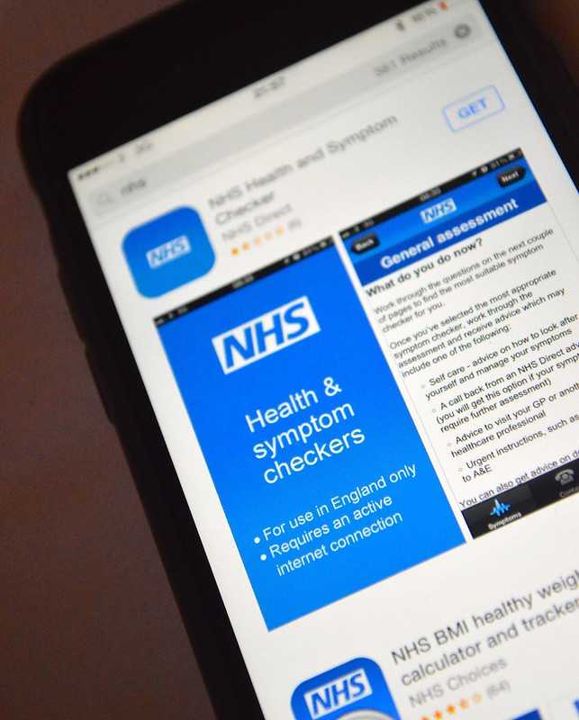iPhone 6 showing Apple App Store search results for NHS, with NHS Health and Symptom Checkers app listing, GET button visible, and partial NHS BMI healthy weight calculator listing.