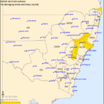Map of New South Wales showing regions under severe weather warning for damaging winds and heavy rainfall.
