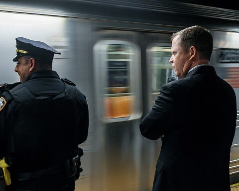 Two senior NYC Transit officials ride a subway train as part of efforts to oversee public safety initiatives.