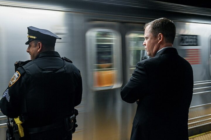 Two senior NYC Transit officials ride a subway train as part of efforts to oversee public safety initiatives.