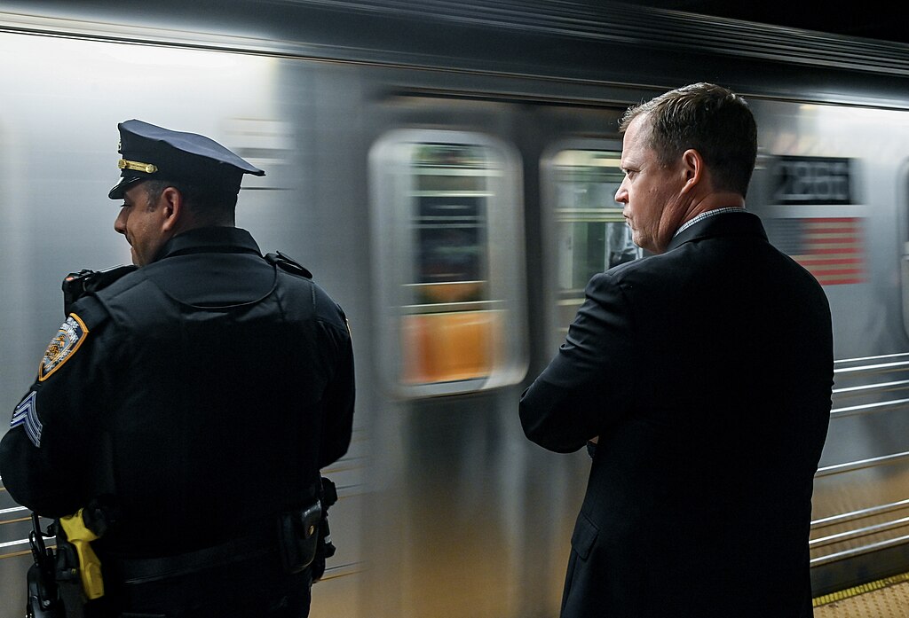 Two senior NYC Transit officials ride a subway train as part of efforts to oversee public safety initiatives.