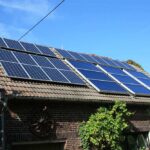 Barn roof in Western Europe with multiple solar panels installed, part of a combined heat and power system generating electricity and heat.