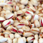 Close-up of shelled and unshelled pistachio nuts, photographed at a processing facility in Iran.