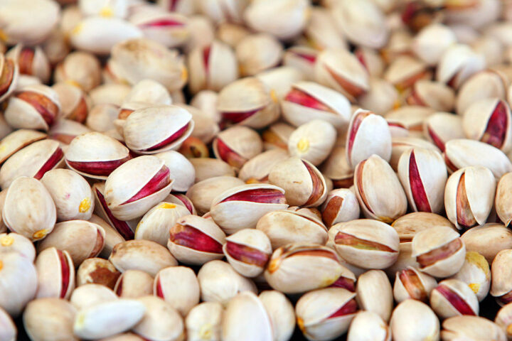 Close-up of shelled and unshelled pistachio nuts, photographed at a processing facility in Iran.