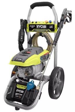 Ryobi electric pressure washer model RY142711VNM with green and black color scheme, featuring a detergent tank with blue cap and spray nozzle attachment on wheels.