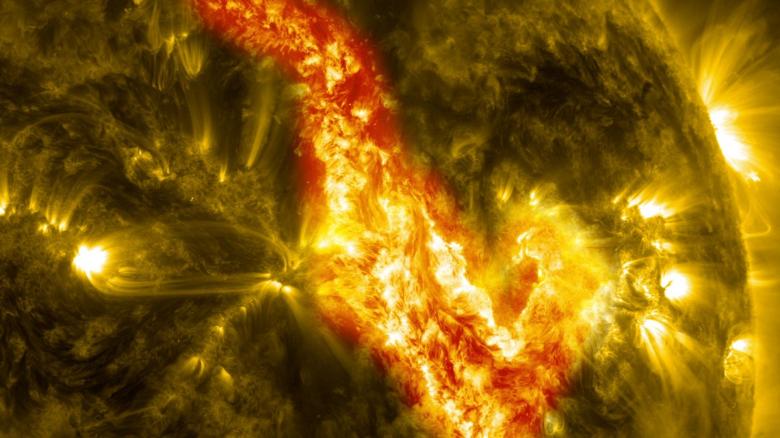 Solar surface close-up showing bright active region with flares and prominences