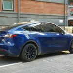 Tesla Model Y Dual Motor Deep Blue Metallic SUV parked outdoors
