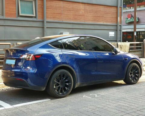 Tesla Model Y Dual Motor Deep Blue Metallic SUV parked outdoors
