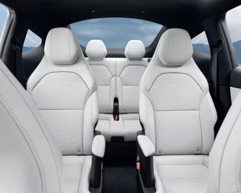 Interior view of Tesla Model YL showing white leather seats in a 2-2-2 configuration with individual captain's chairs in the second row and a clear path to the third row, highlighting the vehicle's premium 6-seat layout.