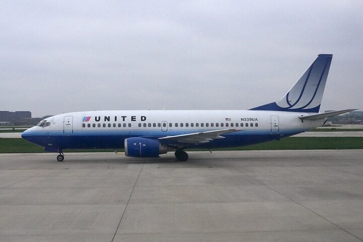United Airlines Boeing 737-800 parked on airport tarmac,