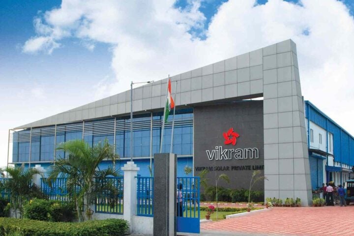 Alt Text: Vikram Solar corporate headquarters building with national flag at entrance