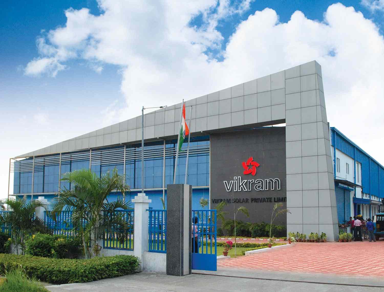 Alt Text: Vikram Solar corporate headquarters building with national flag at entrance