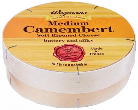 Round wooden box of Wegmans Medium Camembert Soft Ripened Cheese with French origin label and red cave-ripened seal