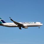 WestJet aircraft in flight representing the airline’s international route expansion strategy and Canadian connectivity to Mexican destinations.