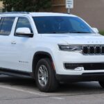 White 2022 Jeep Wagoneer Series I SUV parked on a street, showing front right angle view of the luxury vehicle affected by recent safety recalls.