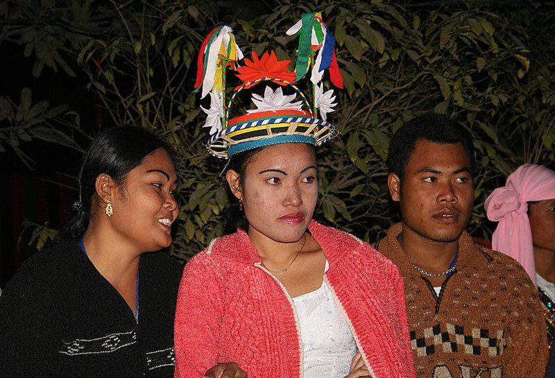 Nicobarese tribal members performing a traditional circular dance on a beach under a full moon during the Ossuary Feast on Car Nicobar Island.