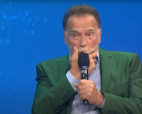Arnold Schwarzenegger speaking into a microphone during a climate change panel on pollution, organized by the Tony Blair Institute for Global Change.