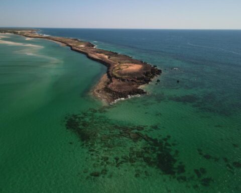 Aerial view of Kimberley coastline with sandy beaches, rocky headlands, and turquoise waters within the Bardi Jawi Gaarra Marine Park in Western Australia.