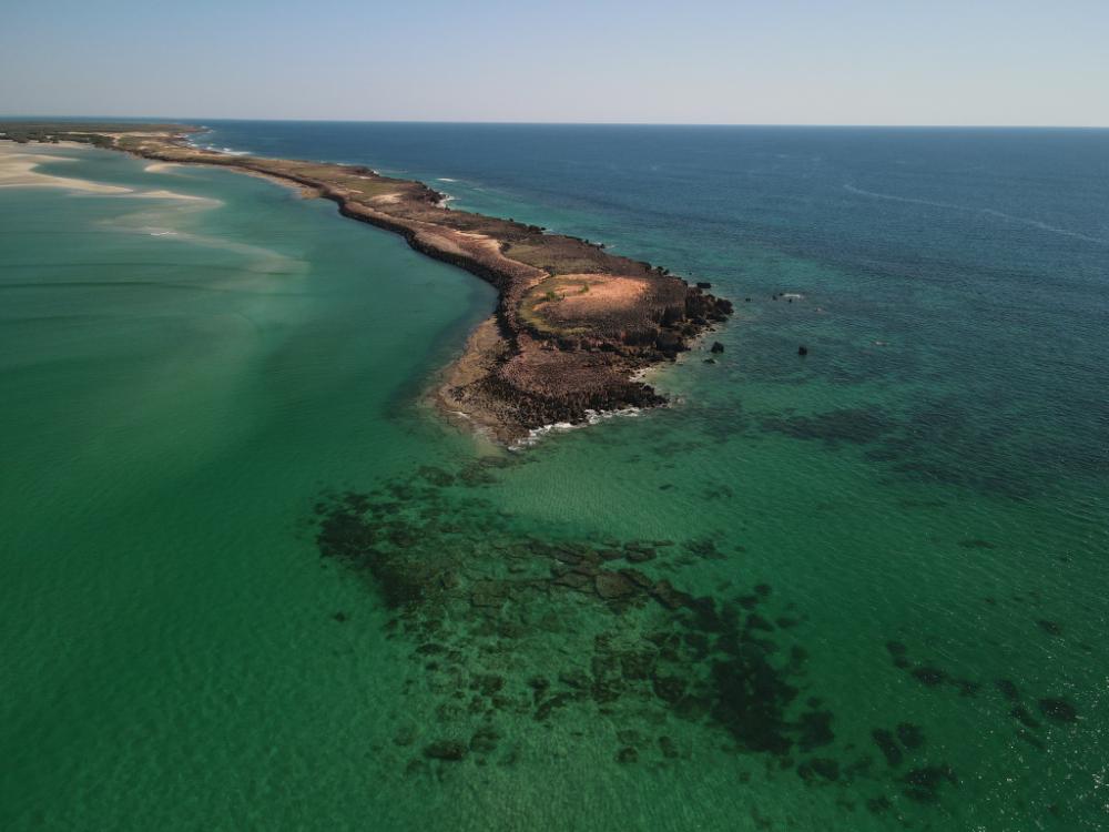 Aerial view of Kimberley coastline with sandy beaches, rocky headlands, and turquoise waters within the Bardi Jawi Gaarra Marine Park in Western Australia.
