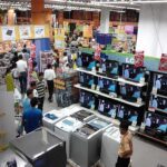 Big Bazaar store interior at Esplanade, Kolkata, showing shoppers among refrigerators, TVs, and appliances on display.